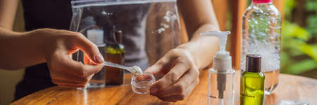 A woman shifts cosmetics to take with herの写真素材