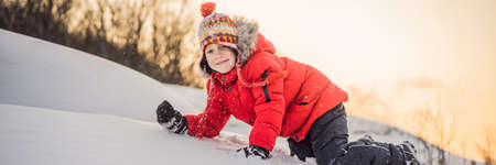 Boy in red fashion clothes playing outdoors.の写真素材