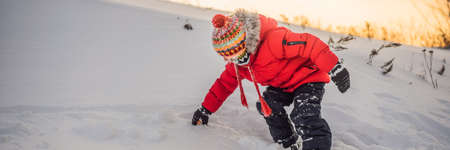 Boy in red fashion clothes playing outdoors.の写真素材