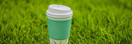 Paper cup of coffee on the grassの写真素材