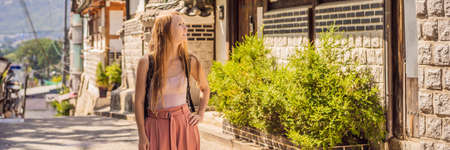 Young woman tourist in Bukchon Hanok Village is one of the famous place for Korean traditional houses have been preserved.の写真素材