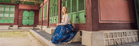 Young caucasian female tourist in hanbok national korean dress Travel to Korea concept.の写真素材