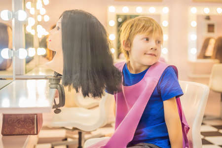 Boy playing as hairdresser in the  beauty salonの写真素材