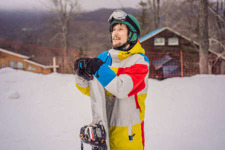 Male snowboarder at a ski resort in winter