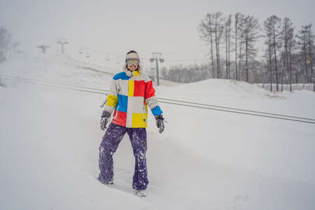 A man throws snow and enjoys the winter, outside.の写真素材
