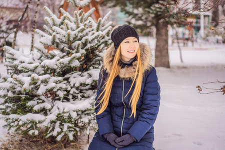 Young woman enjoys a winter snowy day in a snowy forest