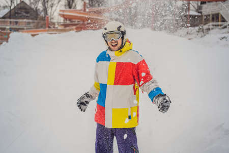 A man throws snow and enjoys the winter, outside.の写真素材
