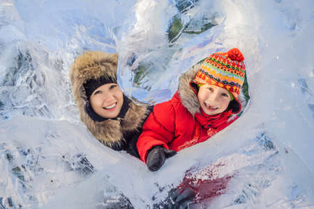 Mother and son enjoying beautiful winter day outdoorsの写真素材