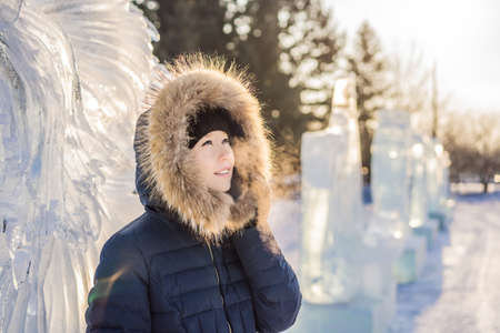 beautiful smiling young woman among the ice in wintertime outdoor. Winter conceptの写真素材