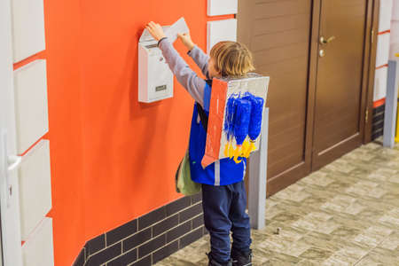 The boy plays that he is a postman