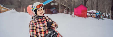 Woman snowboarder on a sunny winter day at a ski resort BANNER, LONG FORMATの写真素材