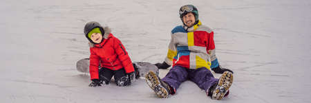 Snowboard instructor teaches a boy to snowboarding. Activities for children in winter. Childrens winter sport. Lifestyle BANNER, LONG FORMATの写真素材