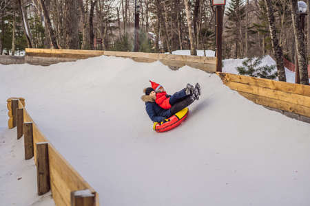mom son ride on an inflatable winter sled tubing. Winter fun for the whole family.