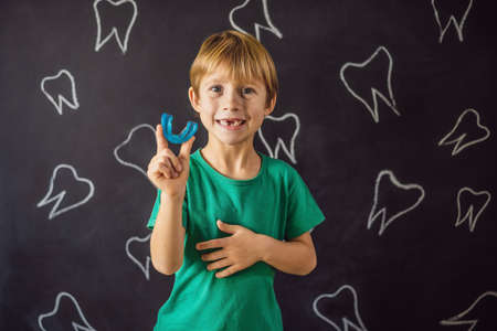 Six-year old boy shows myofunctional trainer. Helps equalize the growing teeth and correct bite,...