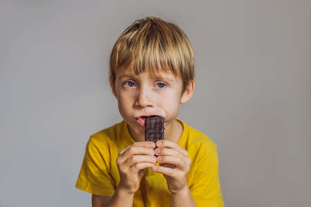 Close Up of Young Boy Eating A chocolate barの写真素材