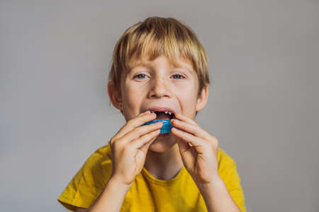 Six-year old boy shows myofunctional trainer. Helps equalize the growing teeth and correct bite, develop mouth breathing habit. Corrects the position of the tongueの写真素材