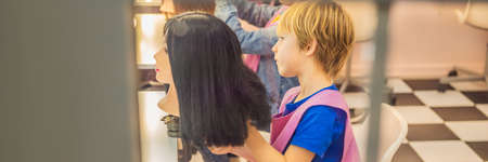 boy hairdresser, day of choice of profession, play at the hairdresser in the childrens beauty salon, hairstylist, hairdressing, barber job BANNER, LONG FORMATの写真素材