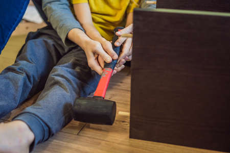 Mother and son assembling furniture. Boy helping his mom at home. Happy Family conceptの写真素材