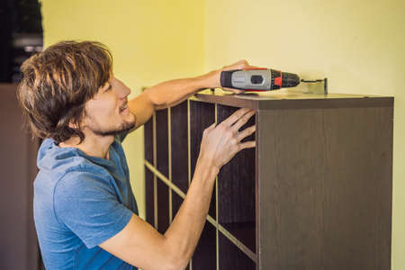 Frustrated Man Putting Together Self Assembly Furniture