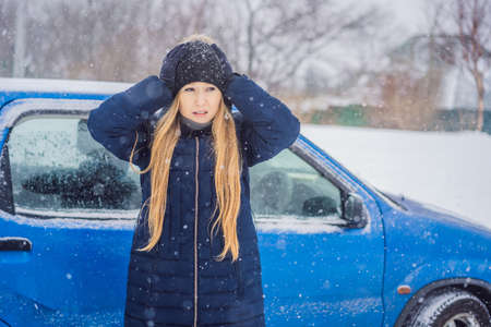The woman was very froze in winter under snowfall. Winter problems