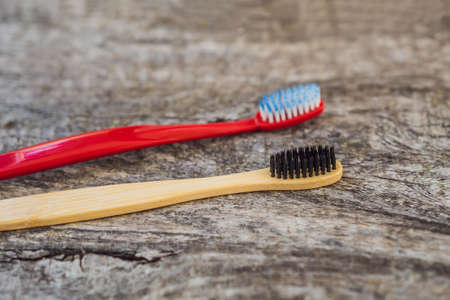 Natural bamboo toothbrush and plastic toothbrush. rustic background. sustainable lifestyle concept. zero waste. choice plastic free items.の写真素材