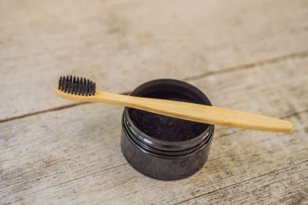 Activated charcoal powder for brushing and whitening teeth. Bamboo eco brush.
