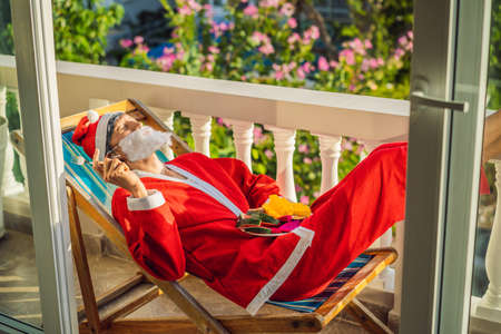 cheerful santa man hold exotic fruit. healthy gift. bearded man healthy eating. merry christmas. happy new year. xmas gifts and presents. winter season. holiday with vitaninの写真素材