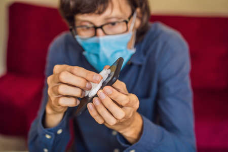 Man cleaning smartphone screen with alcohol or sanitizer. Concept of Cleaning dirty screen phone for disease prevention from bacteria. coronavirus covid 19の写真素材