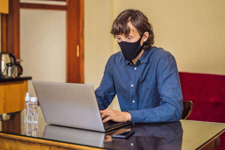 Coronavirus. Man working from home wearing protective mask. quarantine for coronavirus wearing...