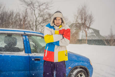 The man was very froze in winter under snowfall. Winter problems