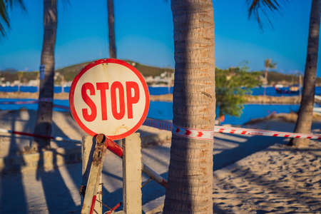 inscription STOP Corona Virus threat closes beaches and public places in many countries. The inscription NOT ALLOWED AREA in English, Vietnameseの写真素材