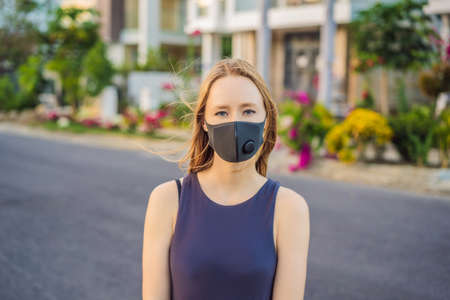 Fashionable black medical mask with filter in the city. Coronavirus 2019-ncov epidemic concept....