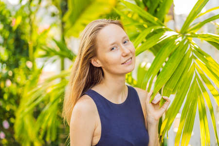 I love my skin. A young woman with freckles, moles, scars and facial wrinkles loves her skin, enjoys...
