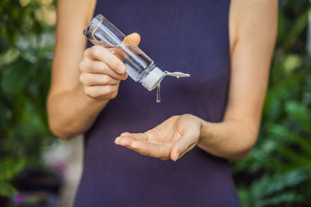 Womens hands using wash hand sanitizer gel