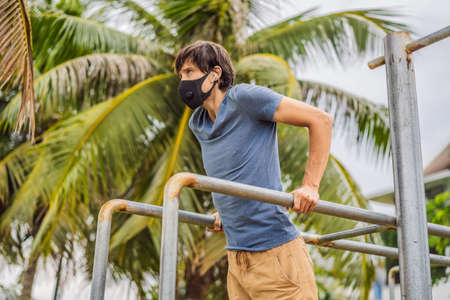 Man in a medical mask plays sports during the coronavirus epidemic
