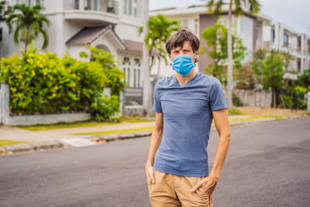 Man in a small town in a medical mask because of a coronovirus epidemic