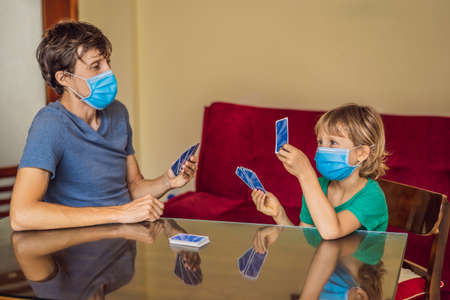 Happy Family Playing Board Game At Home. Stay at home due to quarantine. Coronovirus infectionの写真素材