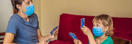 Happy Family Playing Board Game At Home. Stay at home due to quarantine. Coronovirus infection BANNER, LONG FORMATの写真素材
