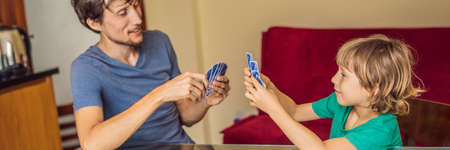 Happy Family Playing Board Game At Home BANNER, LONG FORMATの写真素材