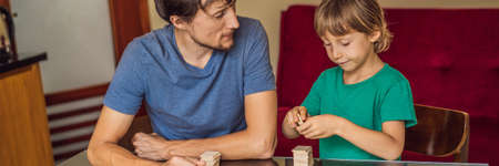 Happy Family Playing Board Game At Home BANNER, LONG FORMAT