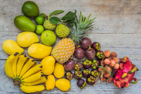 Lots of fruits on a wooden table.の写真素材
