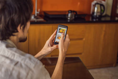 man orders food for lunch online using smartphoneの写真素材