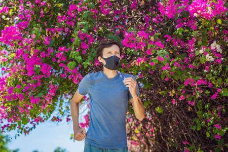 Man runner wearing medical mask. Running in the park. Coronavirus pandemic Covid-19. Sport, Active...