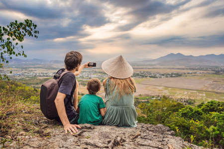 Happy tourists mom, dad and son travel to Vietnam. Travel to Asia concept. Traveling with kids...