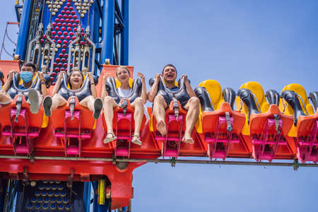 Vietnam, Nha Trang, 24.05.2020: Happy friends in medical mask in an amusement park on a summer day after a coronovirus epidemicのeditorial素材