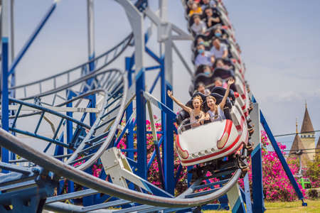 Happy friends in amusement park on a summer dayの写真素材
