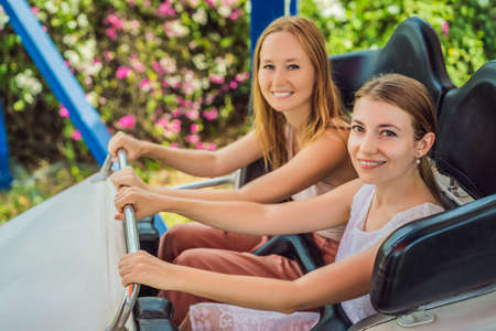 Happy friends in amusement park on a summer dayの写真素材