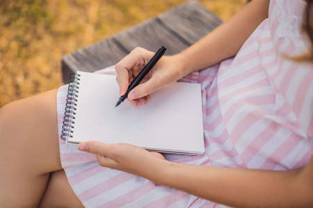 MOCKUP, SCENE CREATOR Women's hands in a tropical background holding a signboard mockupの写真素材