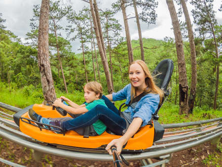 Mother and son on the alpine coasterの写真素材