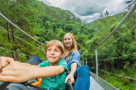 Mother and son on the alpine coasterの写真素材